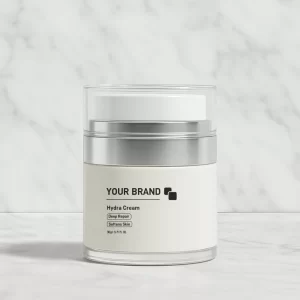 White and silver airless pump jar of 'Hydra Cream' for deep repair and skin softening, on a marble background.